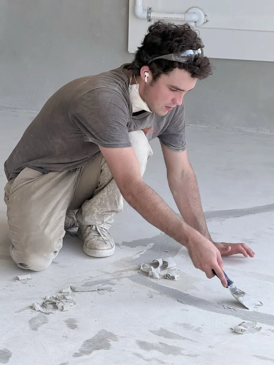 Close-up of crack repair and concrete detail work before epoxy floor coating