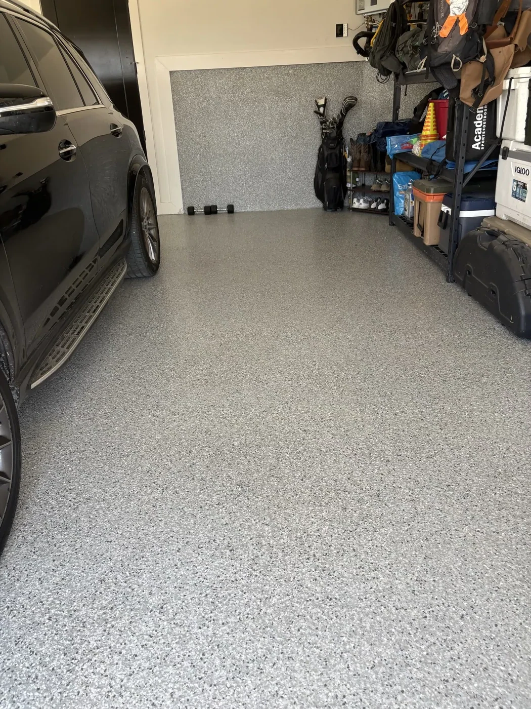 Finished gray flake epoxy garage floor after photo with vehicle parked inside